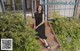 A woman in a black dress sitting on some steps.